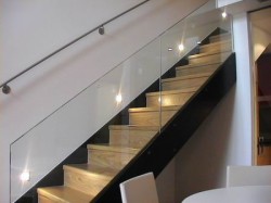 schodiště s proskleným zábradlím a kovovým madlem